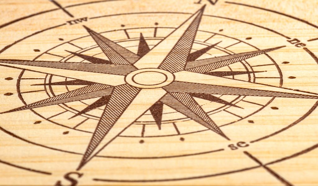 wind rose painted on a wooden plank